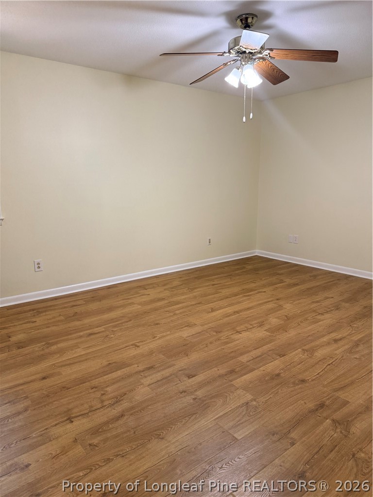 425 Dunmore Road Fayetteville, NC 28303 - Photo 14 of 21 en empty room with wooden floor fan and window