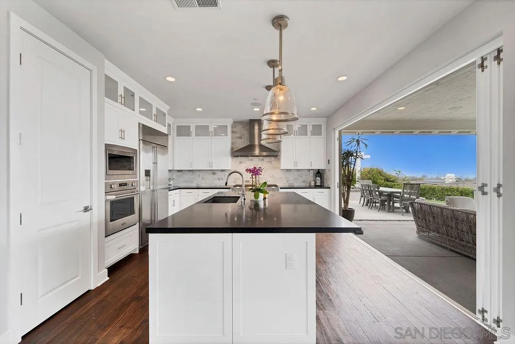 896 Channel Island Drive Encinitas, CA 92024 - Photo 12 of 51 a kitchen with a sink appliances and wooden floor