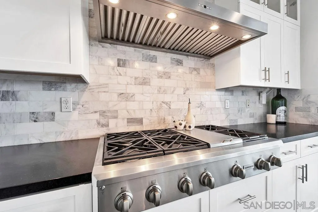 896 Channel Island Drive Encinitas, CA 92024 - Photo 13 of 51 a kitchen with granite countertop a stove sink and cabinets