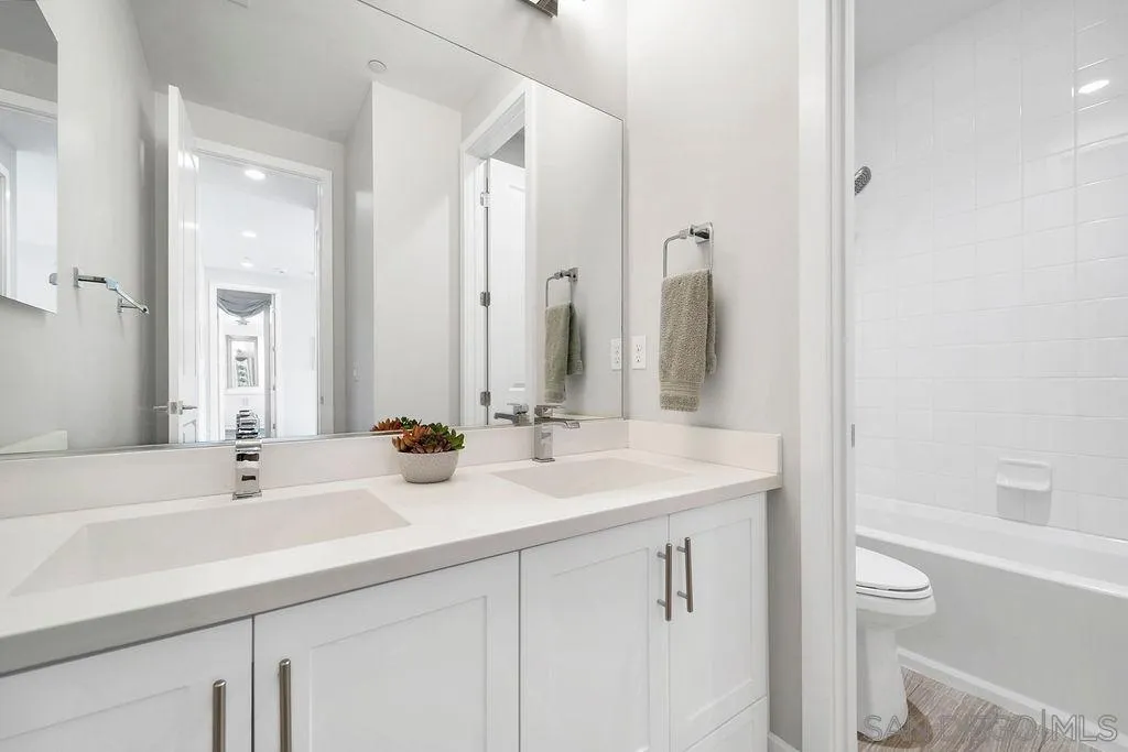 896 Channel Island Drive Encinitas, CA 92024 - Photo 29 of 51 a bathroom with a sink a toilet a large mirror and shower