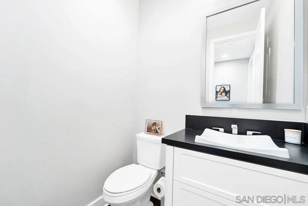 896 Channel Island Drive Encinitas, CA 92024 - Photo 32 of 51 a bathroom with a toilet a sink and mirror