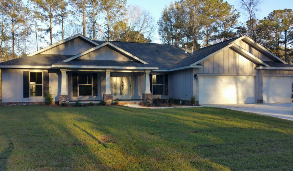 6007 Walk Along Way Crestview, FL 32536 - Photo 1 of 39 a front view of a house with swimming pool having outdoor seating