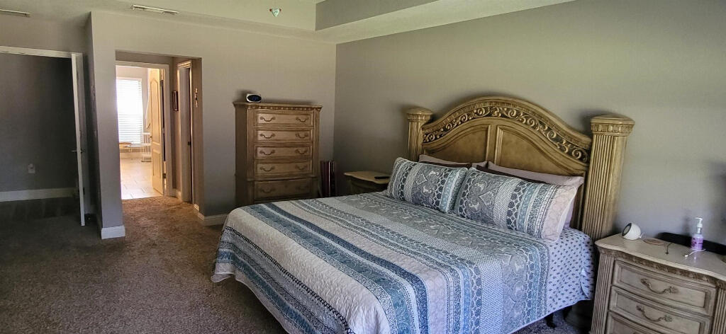 6007 Walk Along Way Crestview, FL 32536 - Photo 15 of 39 a bedroom with a bed and a mirror on dresser