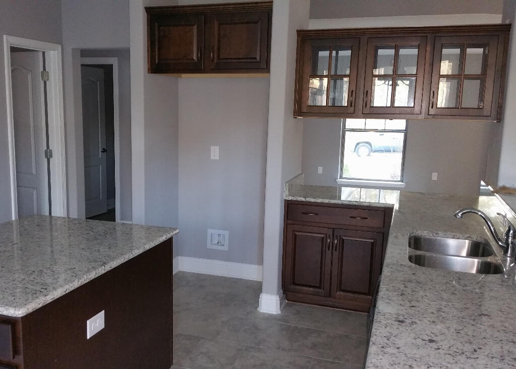 6007 Walk Along Way Crestview, FL 32536 - Photo 7 of 39 a kitchen with a stove and a sink