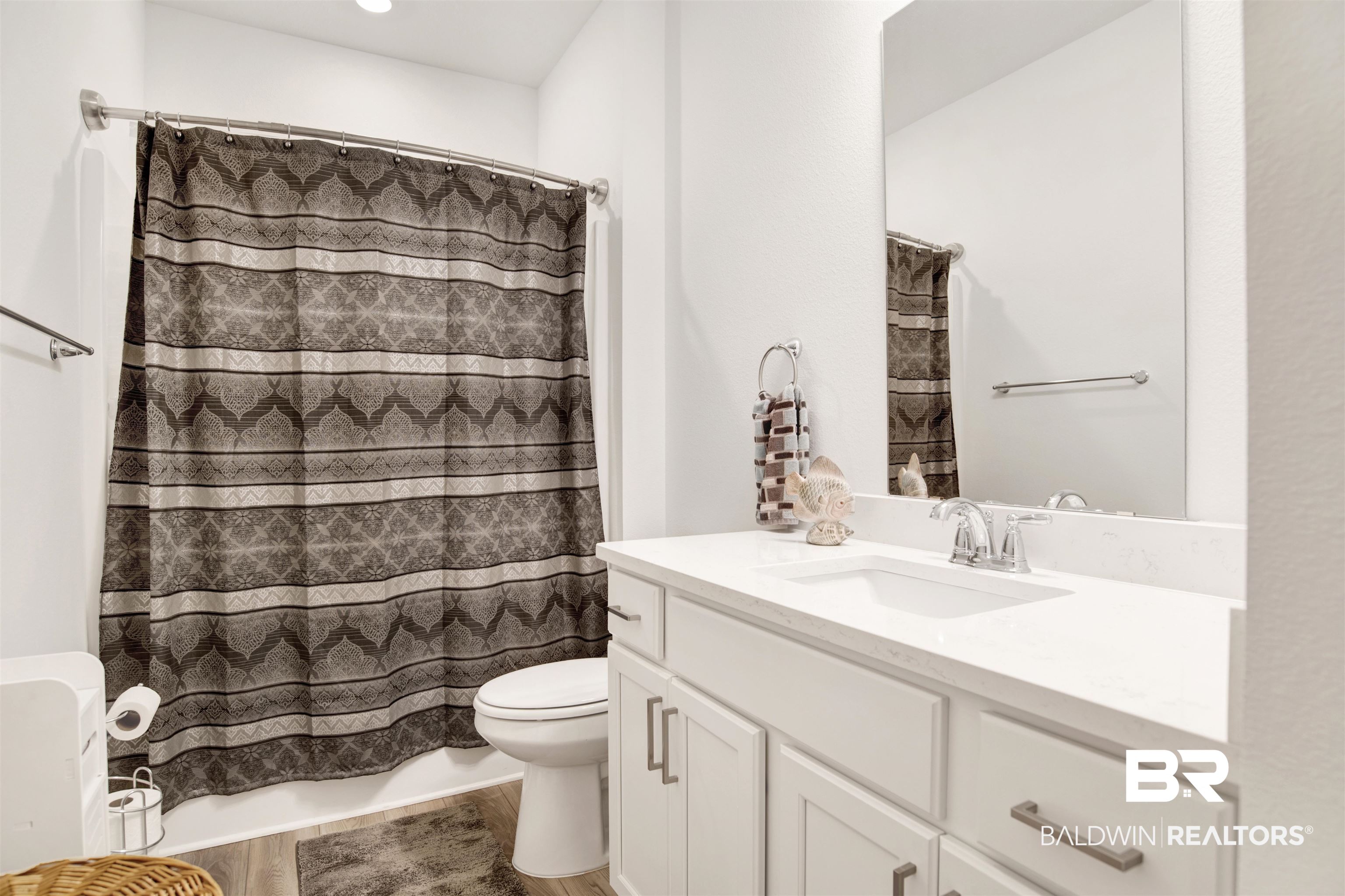 9894 Weller Cove Foley, AL 36535 - Photo 17 of 23 Full bathroom featuring vanity and wood finished floors