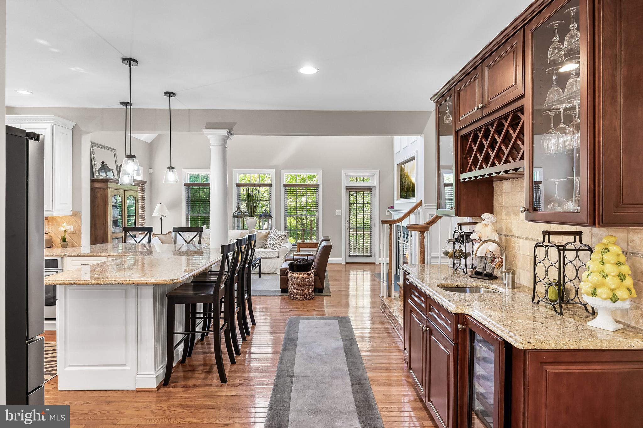 5 Collins Mill Court Moorestown, NJ 08057 - Photo 11 of 49 a kitchen with granite countertop a stove a sink a dining table and chairs