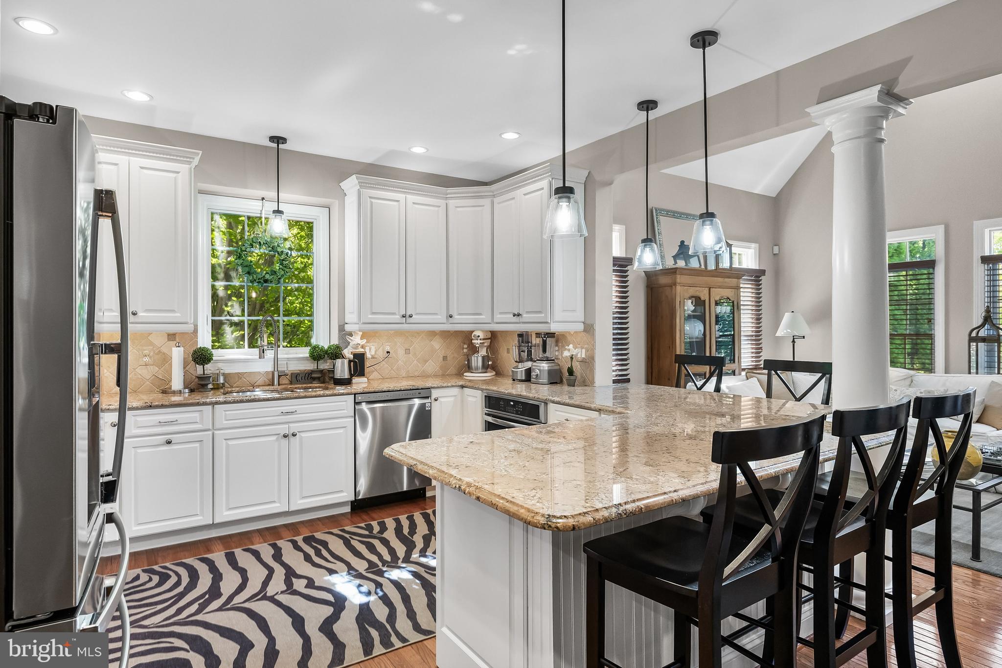 5 Collins Mill Court Moorestown, NJ 08057 - Photo 12 of 49 a kitchen with a table chairs stove and microwave