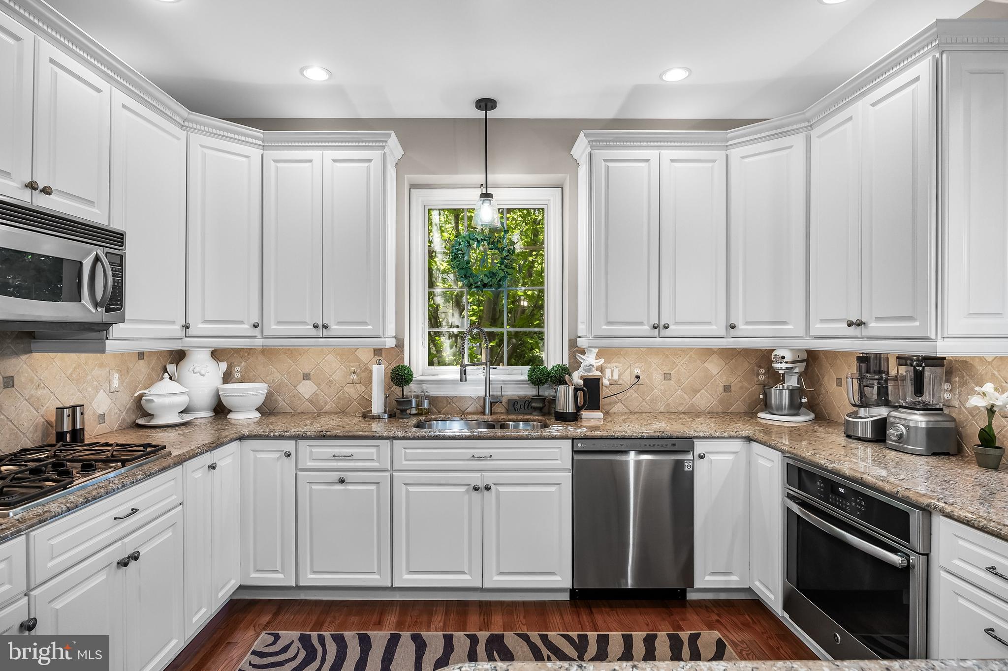 5 Collins Mill Court Moorestown, NJ 08057 - Photo 13 of 49 a kitchen with granite countertop white cabinets and white appliances