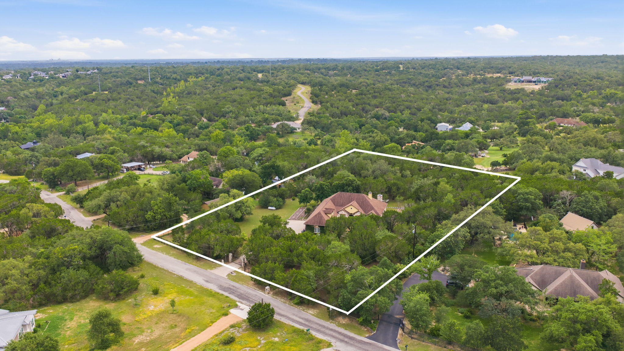 8121 Bluff Trail Austin, TX 78737 - Photo 38 of 40 An aerial perspective reveals a secluded residence nestled within a vast, verdant landscape.