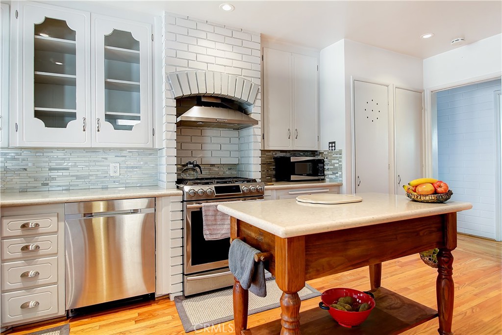 4662 Sierra Street Riverside, CA 92504 - Photo 13 of 41 a kitchen with a sink cabinets and wooden floor