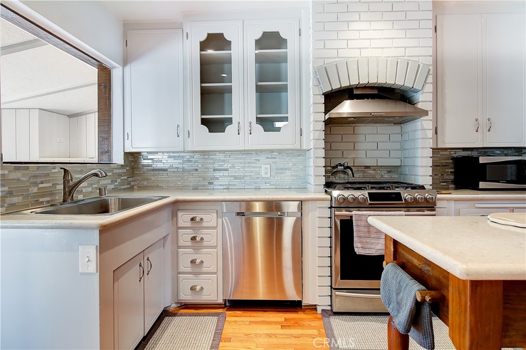 4662 Sierra Street Riverside, CA 92504 - Photo 14 of 41 a kitchen with stainless steel appliances granite countertop a sink stove and refrigerator