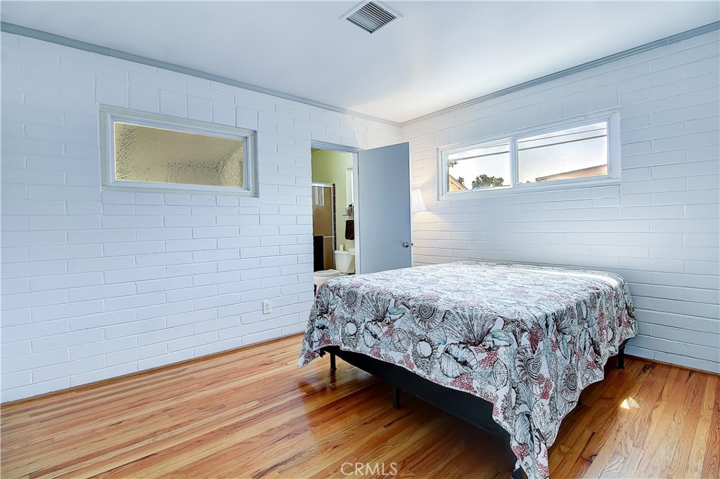 4662 Sierra Street Riverside, CA 92504 - Photo 22 of 41 a bedroom with a bed and wooden floor