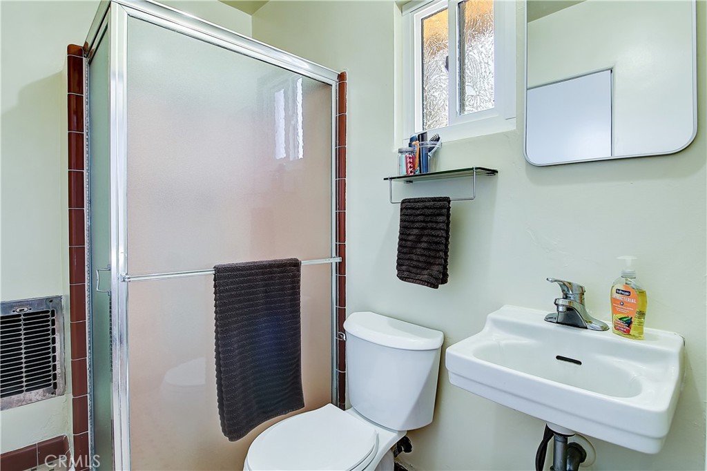 4662 Sierra Street Riverside, CA 92504 - Photo 23 of 41 a bathroom with a toilet sink and mirror
