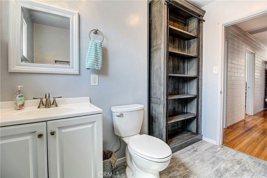 4662 Sierra Street Riverside, CA 92504 - Photo 27 of 41 a bathroom with a toilet a sink and a mirror