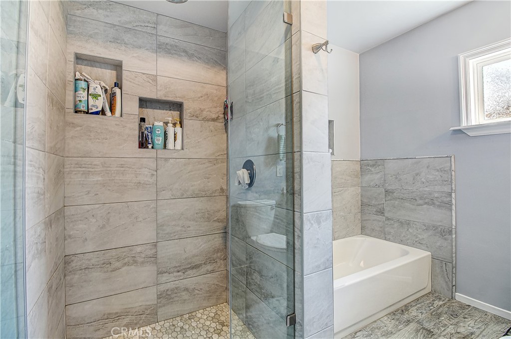 4662 Sierra Street Riverside, CA 92504 - Photo 29 of 41 a bathroom with a bathtub and a shower