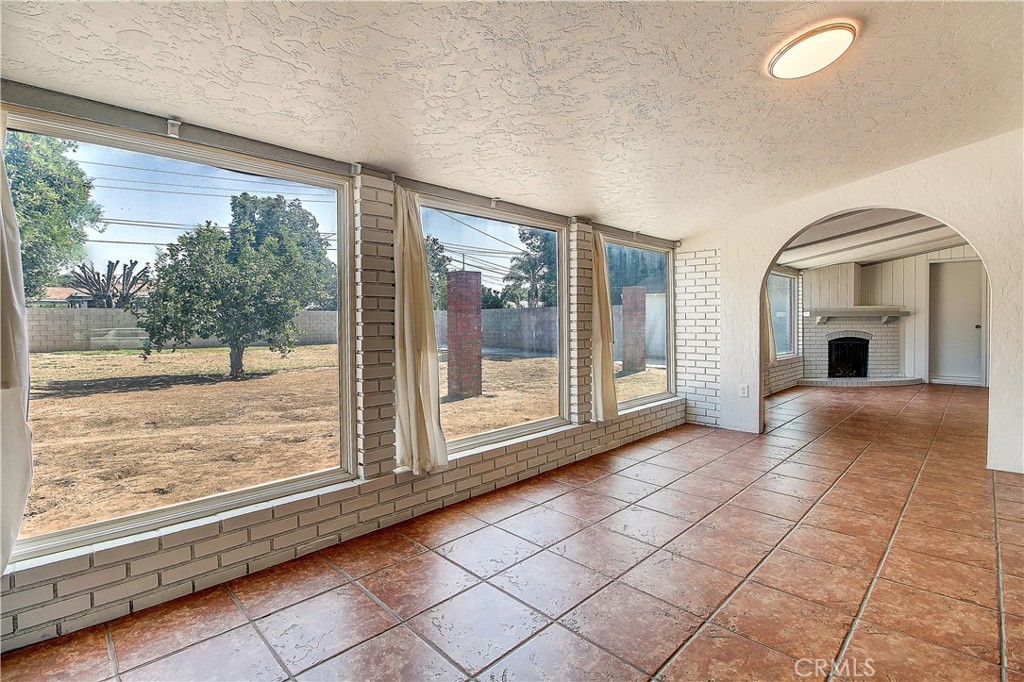 4662 Sierra Street Riverside, CA 92504 - Photo 33 of 41 a view of livingroom with furniture wooden floor and a floor to ceiling window