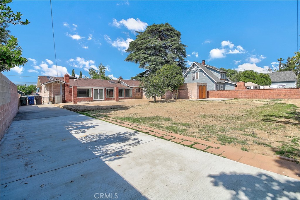 4662 Sierra Street Riverside, CA 92504 - Photo 38 of 41 a view of a white house with a yard and potted plants
