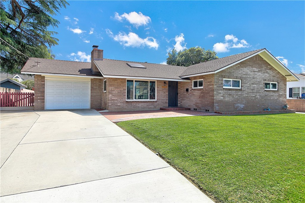 4662 Sierra Street Riverside, CA 92504 - Photo 4 of 41 a front view of a house with a garden and yard