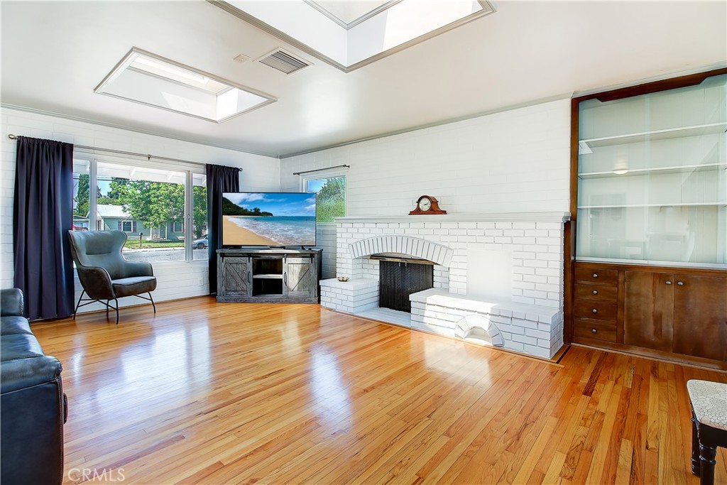 4662 Sierra Street Riverside, CA 92504 - Photo 9 of 41 a view of a livingroom with furniture a fireplace and wooden floor