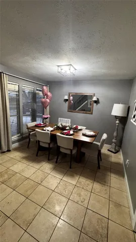 a living room with furniture a rug and a projector