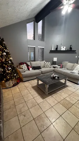 a living room with furniture and flowers