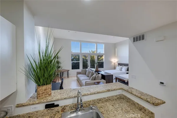 a kitchen with kitchen island a appliances and chairs in it