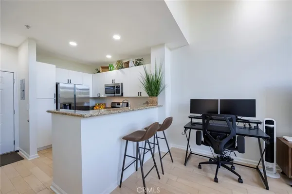 a living room with furniture kitchen view and a table