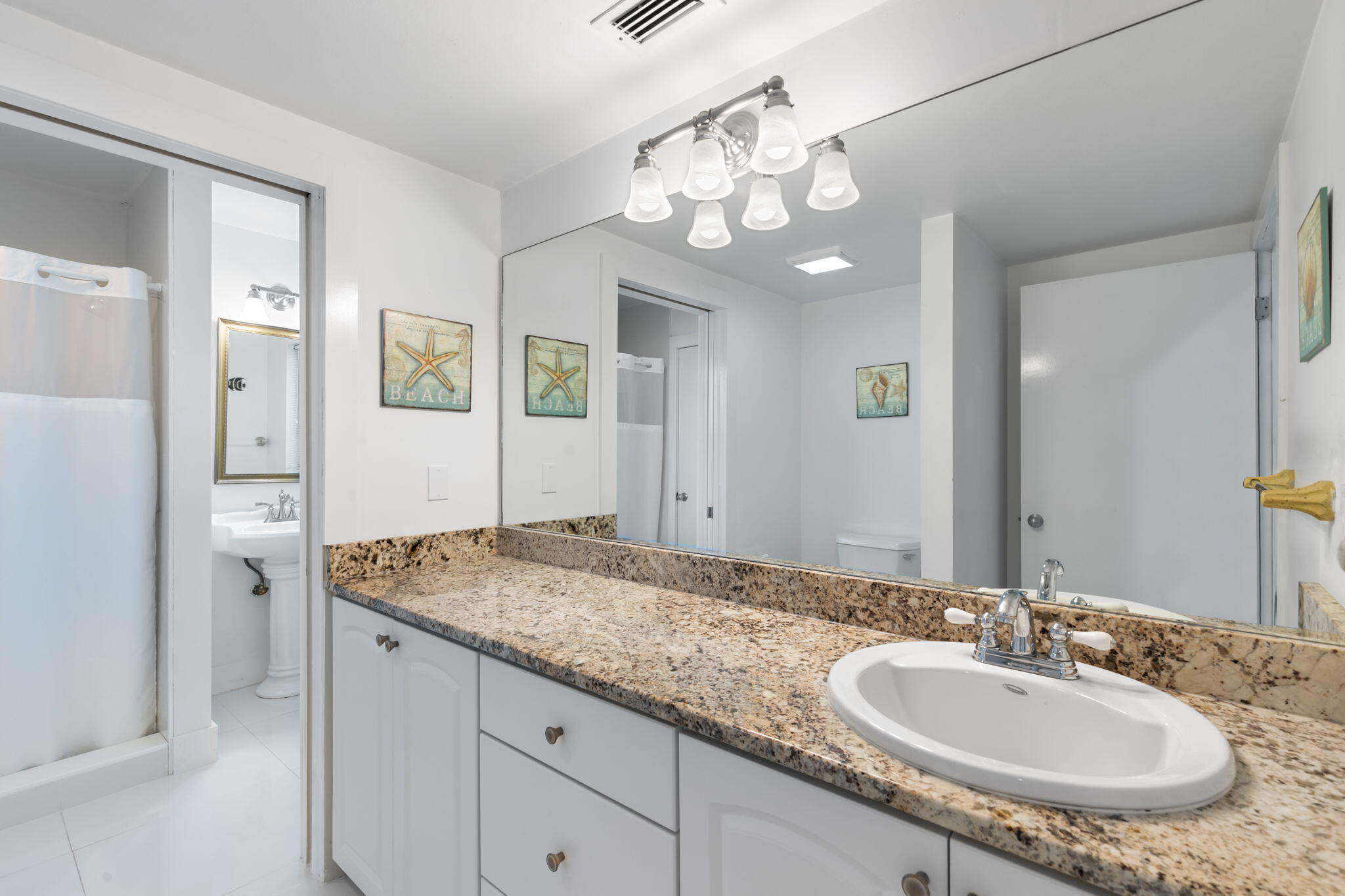 821 Palm Street Marco Island, FL 34145 - Photo 13 of 62 a bathroom with a granite countertop sink and a mirror