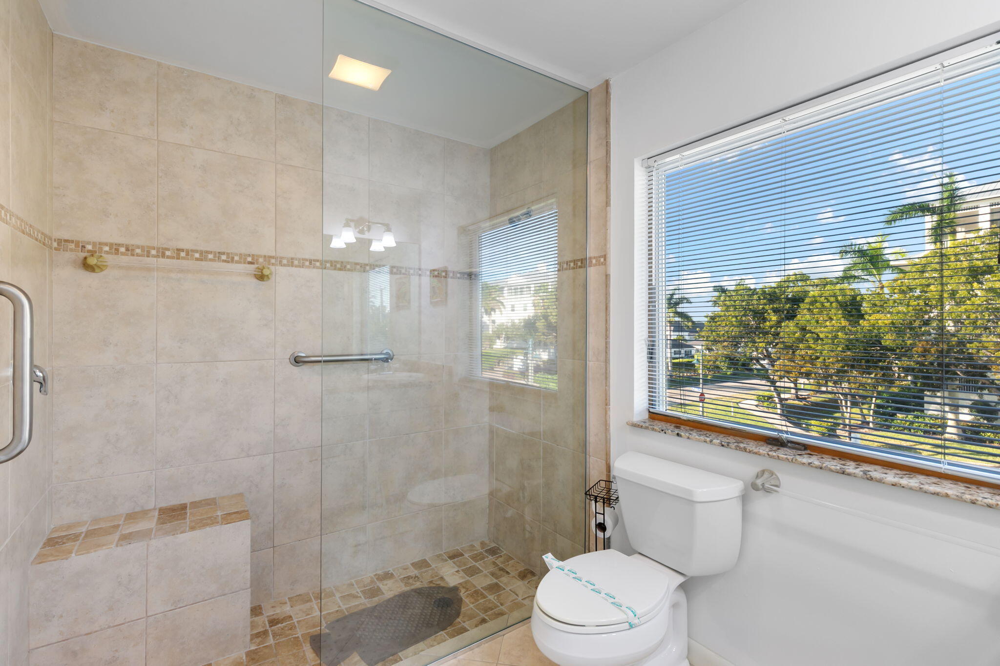 821 Palm Street Marco Island, FL 34145 - Photo 18 of 62 a bathroom with a toilet sink vanity and shower