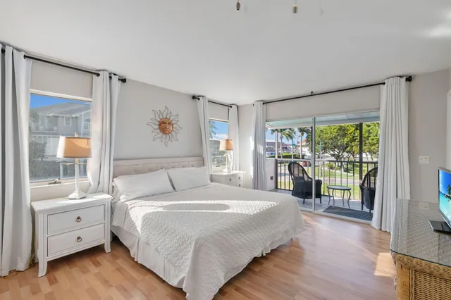 a spacious bedroom with a bed and a dresser