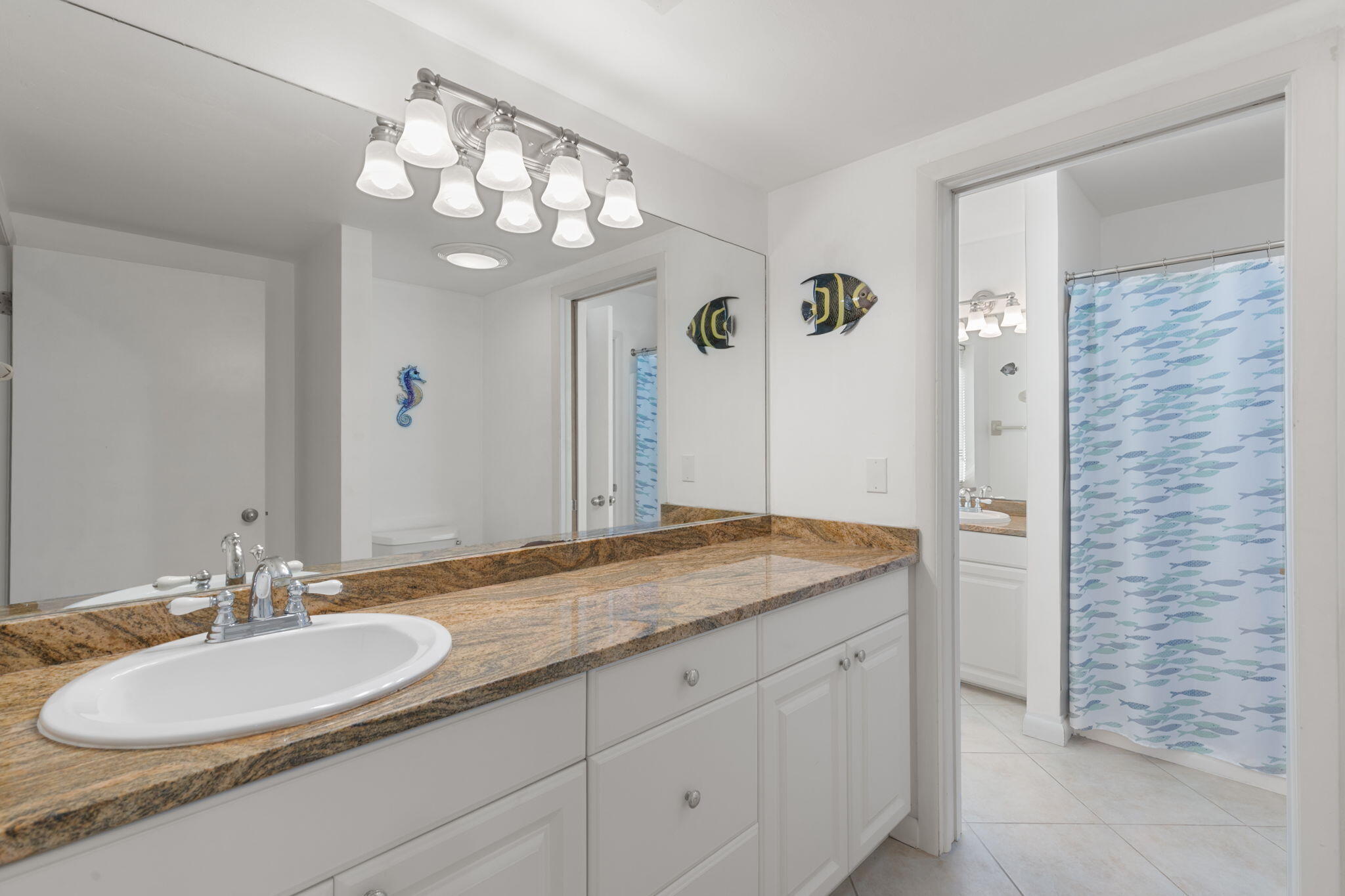821 Palm Street Marco Island, FL 34145 - Photo 27 of 62 a bathroom with a granite countertop sink a large mirror and a shower