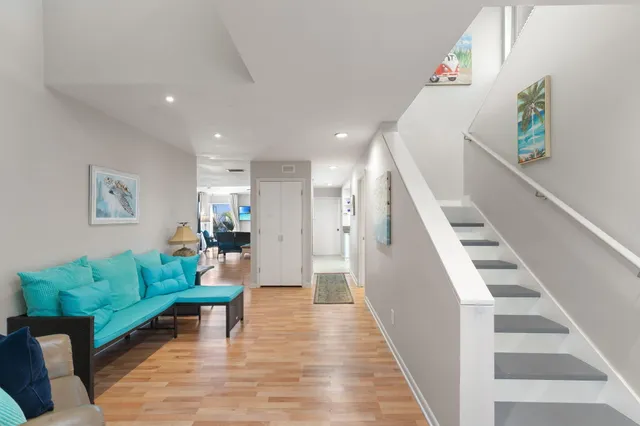 a living room with furniture kitchen view and a table
