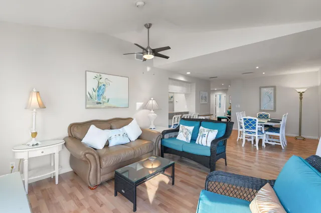 a view of a patio with couches table and chairs and potted plants