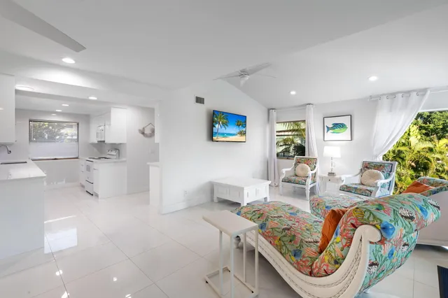 a bedroom with furniture and a large window