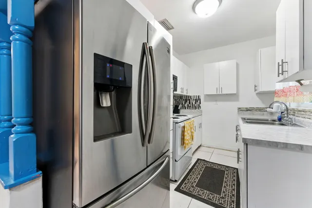 a kitchen with stainless steel appliances granite countertop a stove and a sink with cabinets