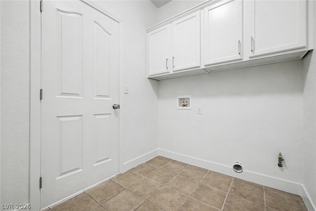 835 Entrada Ridge Avenue Henderson, NV 89012 - Photo 30 of 34 Functional utility room with ample cabinetry and durable tile flooring for everyday convenience.