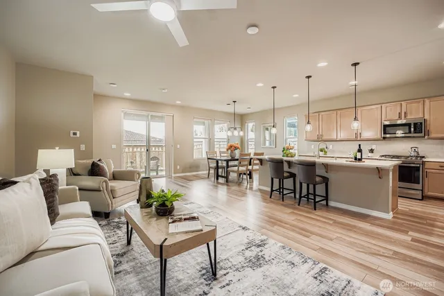 a living room with lots of furniture and kitchen view