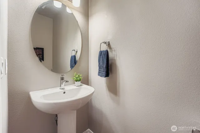 a bathroom with a sink and mirror