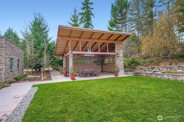 a view of a house with a yard and sitting area