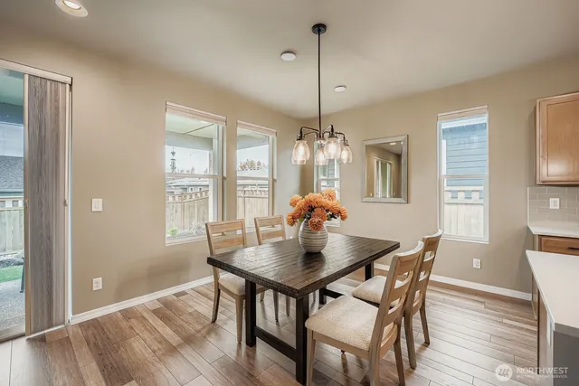 a view of a dining room with furniture window and wooden floor