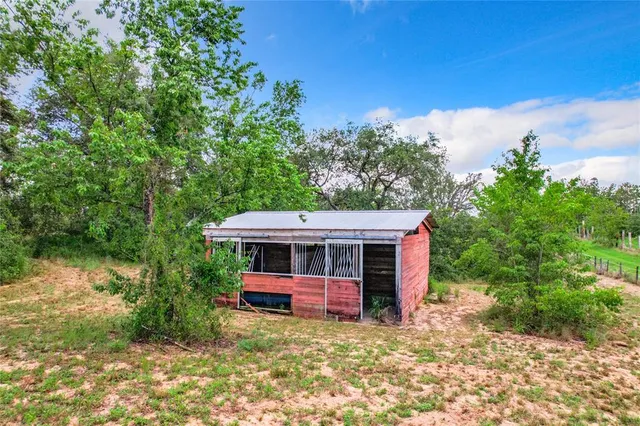 an aerial view of a house with big yard