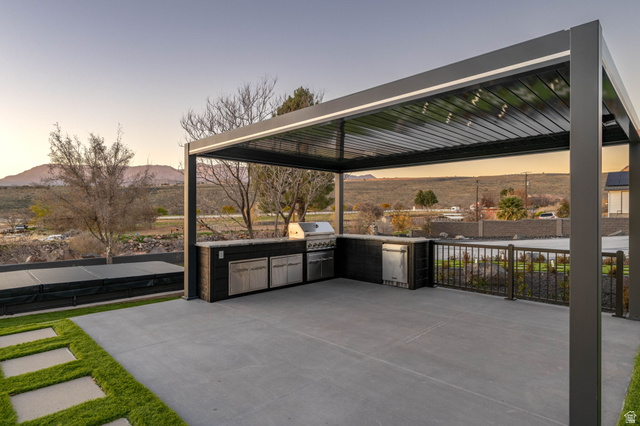 476 Spring Drive Toquerville, UT 84774 - Photo 82 of 95 Patio terrace at dusk featuring area for grilling, a mountain view, and a patio area