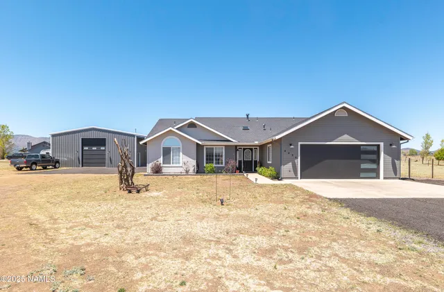 a front view of a house with a yard covered in snow