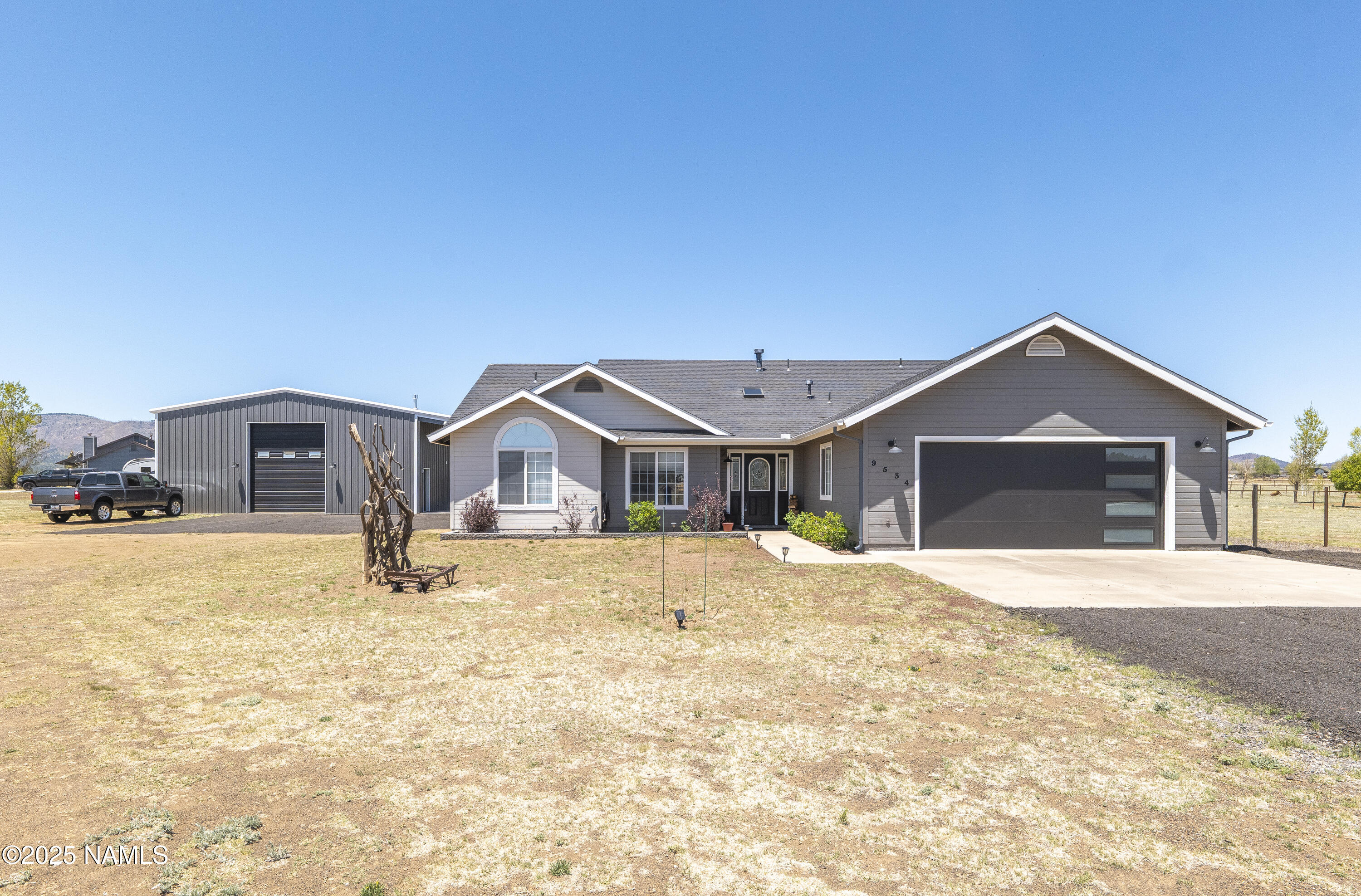 a front view of a house with a yard covered in snow