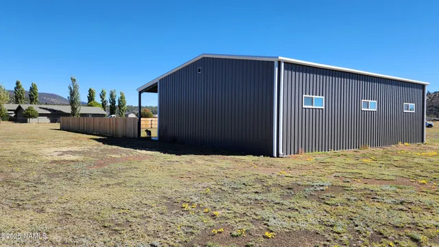 a black car is parked in front of a house
