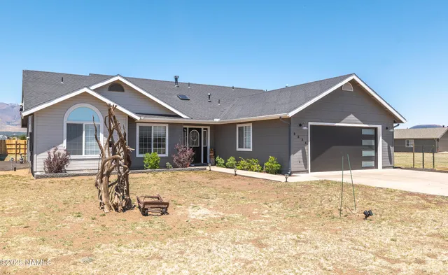 a living room with furniture kitchen view and a chandelier