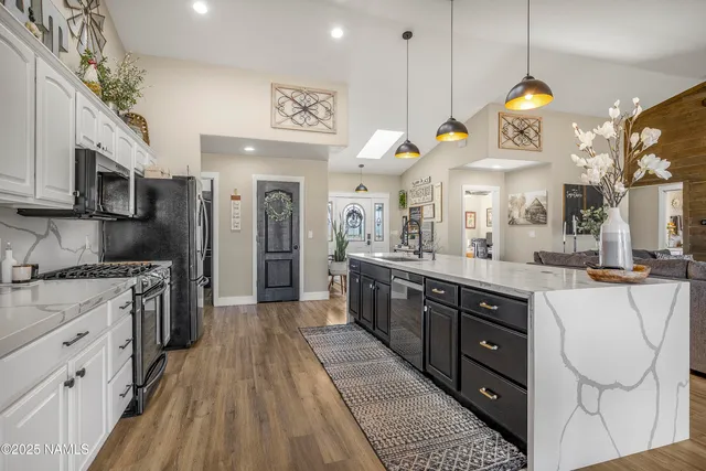 a bathroom with a granite countertop sink a toilet and a large mirror