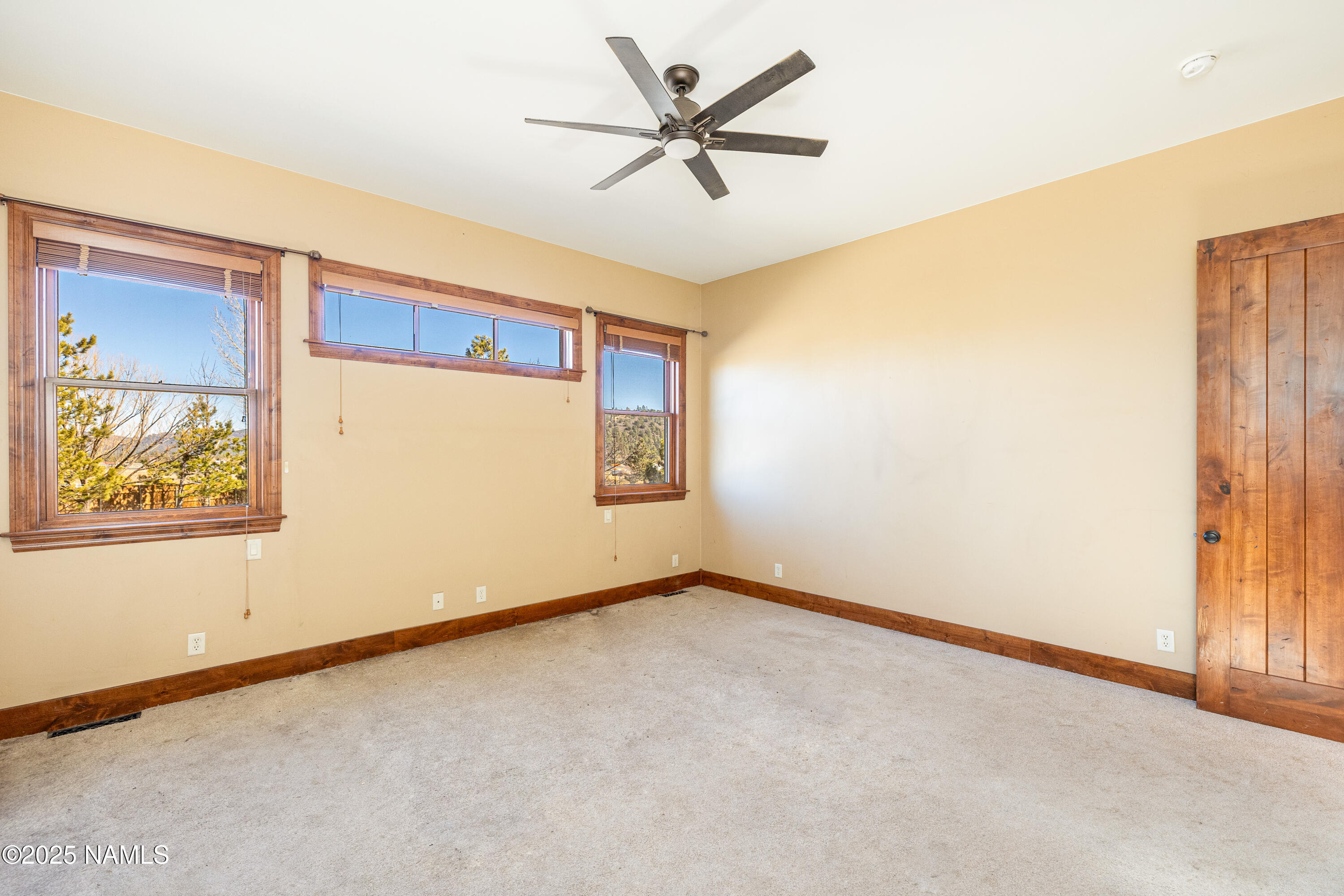 5835 Switchback Trail Flagstaff, AZ 86004 - Photo 14 of 35 an empty room with windows and fan