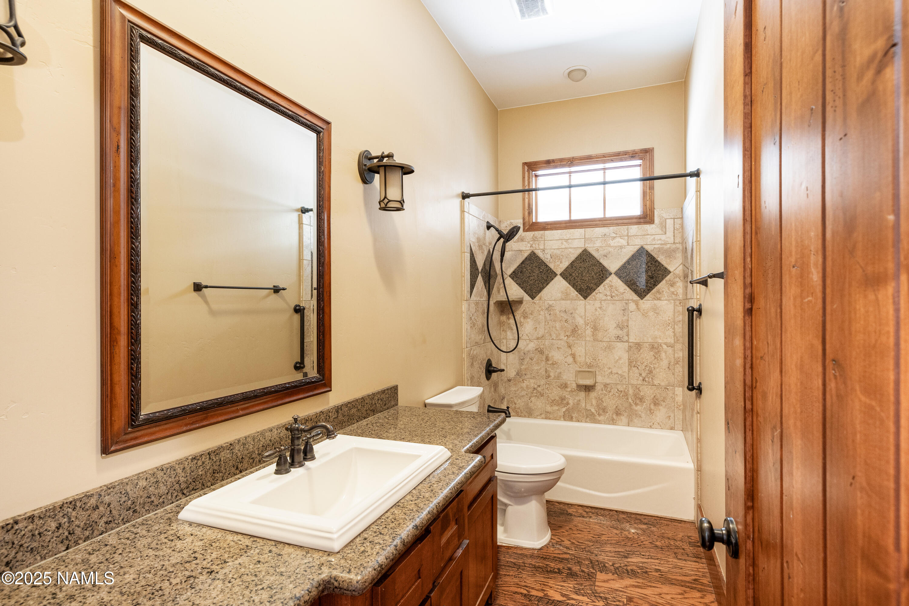5835 Switchback Trail Flagstaff, AZ 86004 - Photo 23 of 35 a bathroom with a granite countertop sink toilet and shower