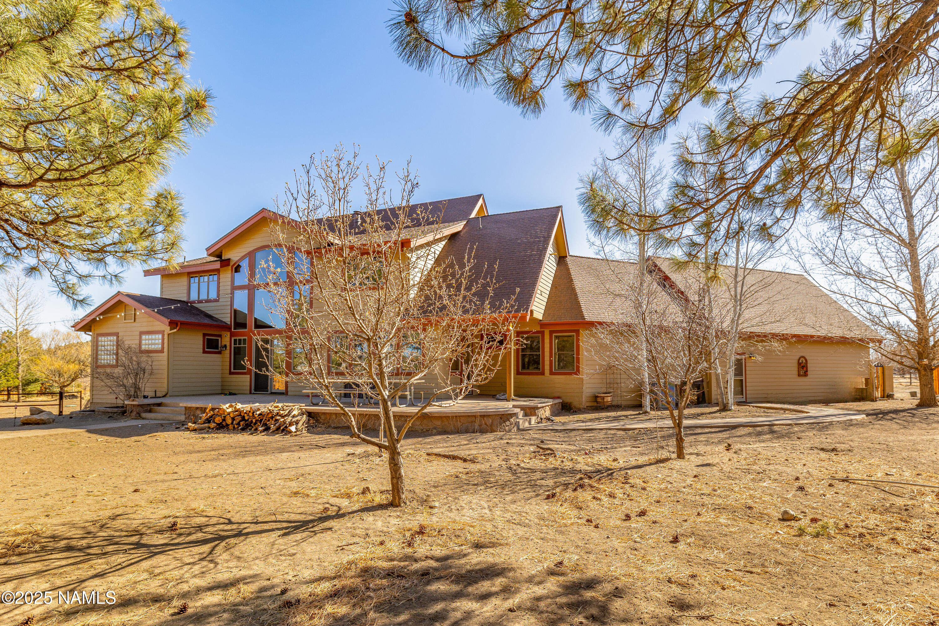 5835 Switchback Trail Flagstaff, AZ 86004 - Photo 3 of 35 a view of a white house with a yard covered in snow